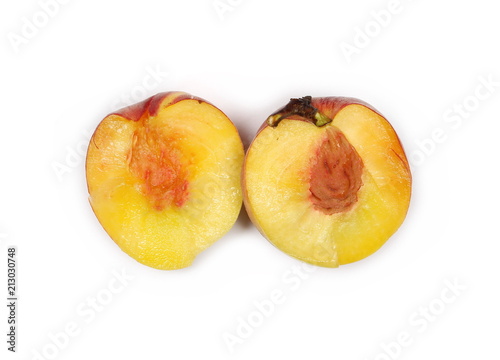 Fresh ripe peach fruit sliced in half isolated on white background, top view