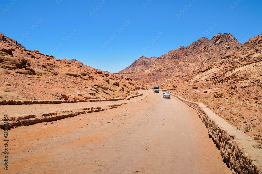 road to the monastery of St. Catherine, pilgrims, tourists go to the monastery, olive trees, buildings, mountains, blue sky road to the monastery of St. Catherine, pilgrims, tourists go to the monastery, olive trees, buildings, mountains, blue sky