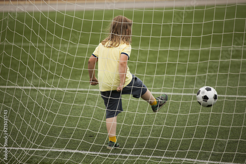 child run soccer  football  player. Boy with ball on green grass