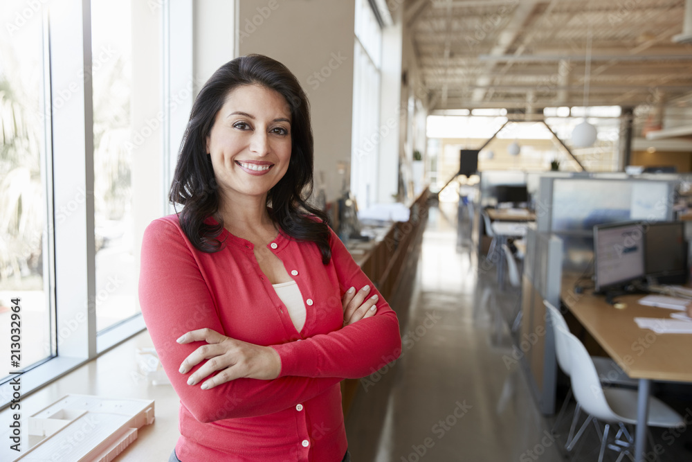 Female Hispanic architect smiling to camera in an office Female Hispanic architect smiling to camera in an office