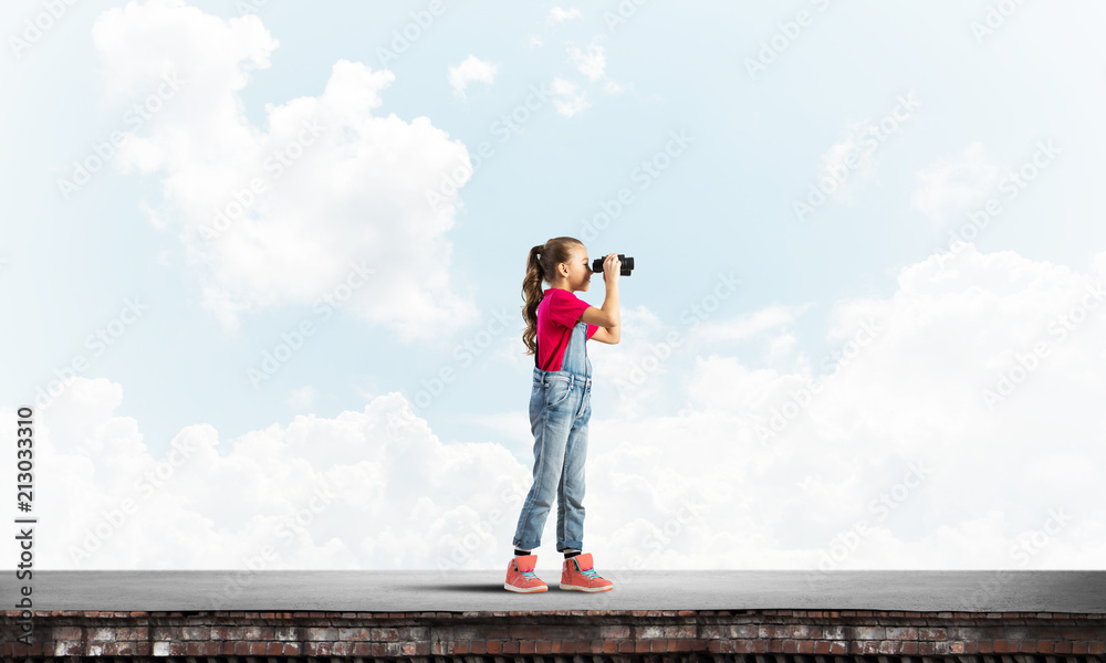 Concept of careless happy childhood with girl of school age looking in future Concept of careless happy childhood with girl of school age looking in future