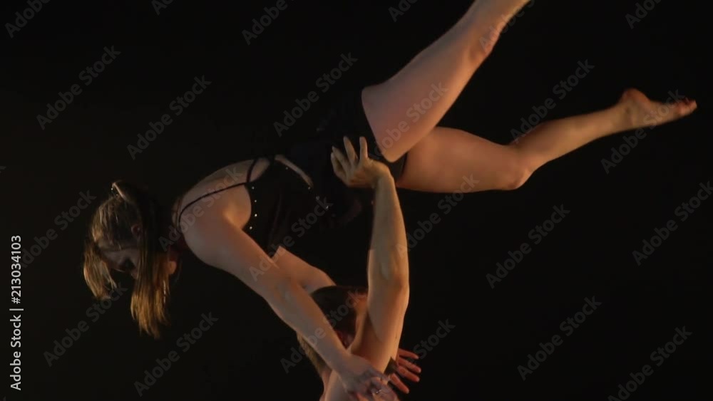 A fat man is engaged with a slender woman acro yoga, slow motion A fat man is engaged with a slender woman acro yoga, slow motion