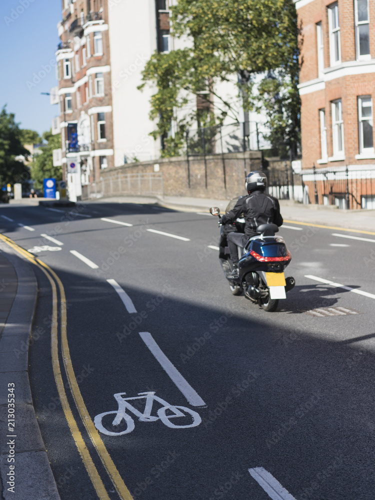 Man riding moped in helmet