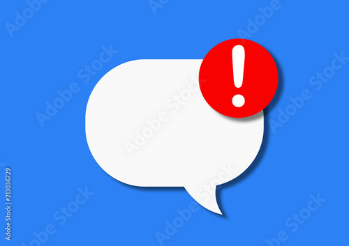 White speech bubble of paper cardboard with a red circle with a look on a blue background. Concept of notification of a new message on the phone or social networks. Flat lay, top view