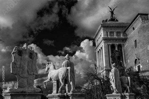 Capitoline Hill monumental balustrade with ancient roman statues and clouds in the historic center of Rome (Black and White)