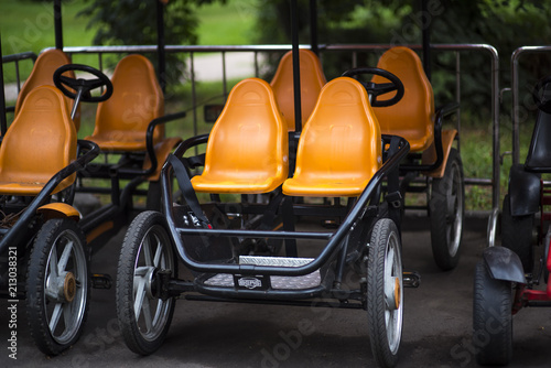 Colorful four-seat bicycle in autodrom in the fairground attractions at amusement park. photo