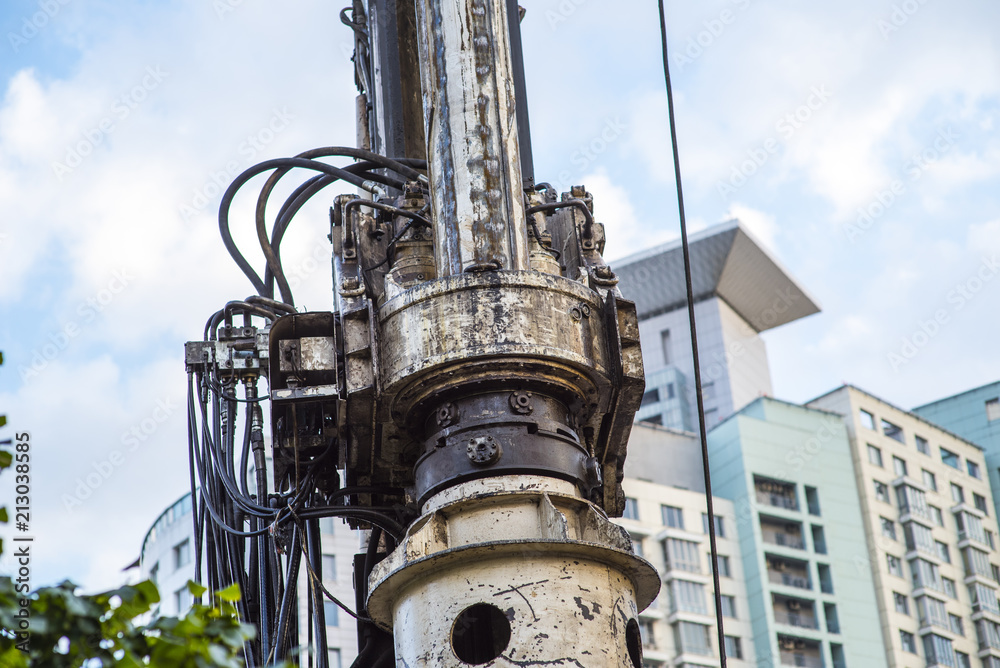 Drilling rig boring hole in city at construction site Drilling rig boring hole in city at construction site