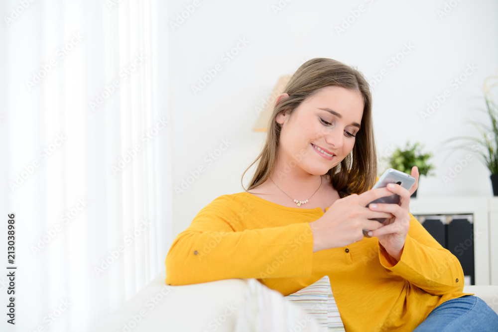 cheerful young woman relaxed on sofa making phone call at home with smartphone telephone technology cheerful young woman relaxed on sofa making phone call at home with smartphone telephone technology