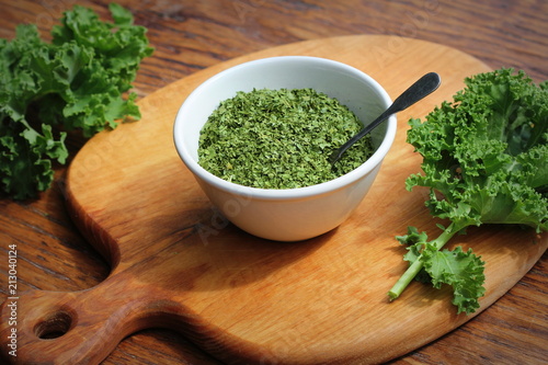 Chopped dry kale leaves on rustic background