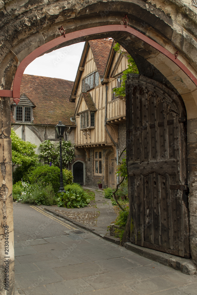 Half timbered medieval houses just inside the King's Gate in the ancient city walls of Winchester, Hampshire, UK