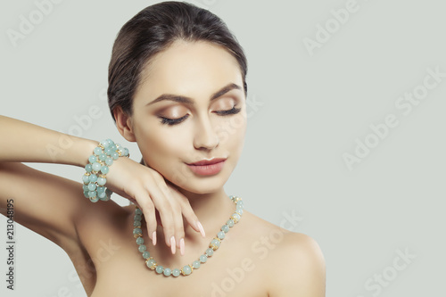 Glamorous Woman Fashion Model with Makeup and Jewelry. Gold Necklace and Bracelet with Semiprecious Stones