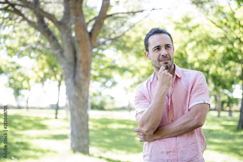 attractive man posing in the park attractive man posing in the park