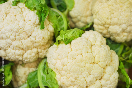 Cauliflower on the counter of the vegetable market. Close-up and top view of fresh vegetables on store shelves.