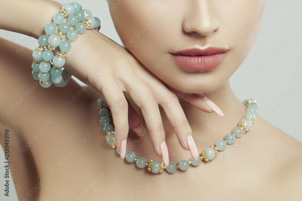 Perfect jewelry on female body, closeup portrait. Bracelet, necklace and manicure