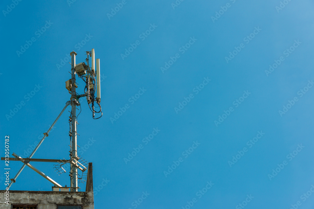 Telecommunication antenna tower with blue sky background Telecommunication antenna tower with blue sky background