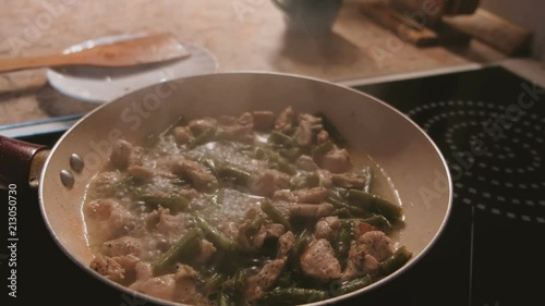 Cooking cicken with beans on the pan. photo