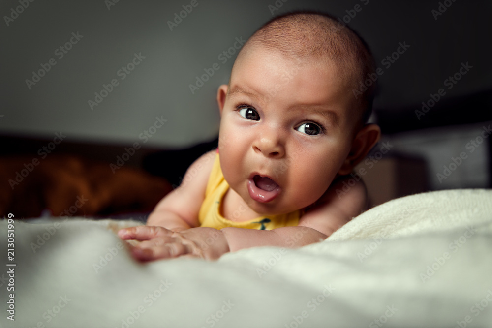 Infant baby newborn holding head and makes funny surprised impression of  the face Stock Photo | Adobe Stock