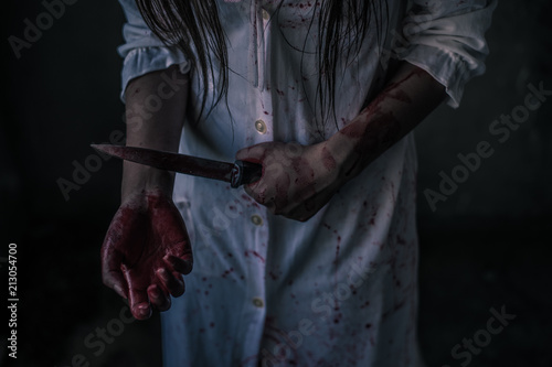 Ghost woman holding knife for kill a man with in house. Horror. Halloween.