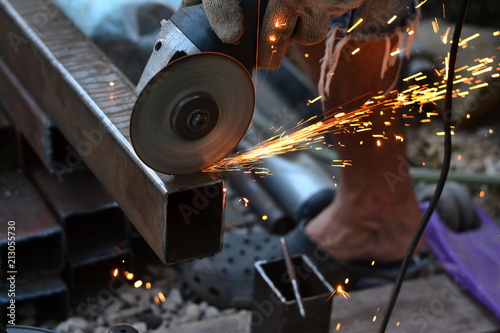 The worker saws the Bulgarian with sparks