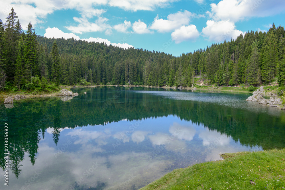 Obraz premium Lake Carezza with reflection of mountains in the Dolomites