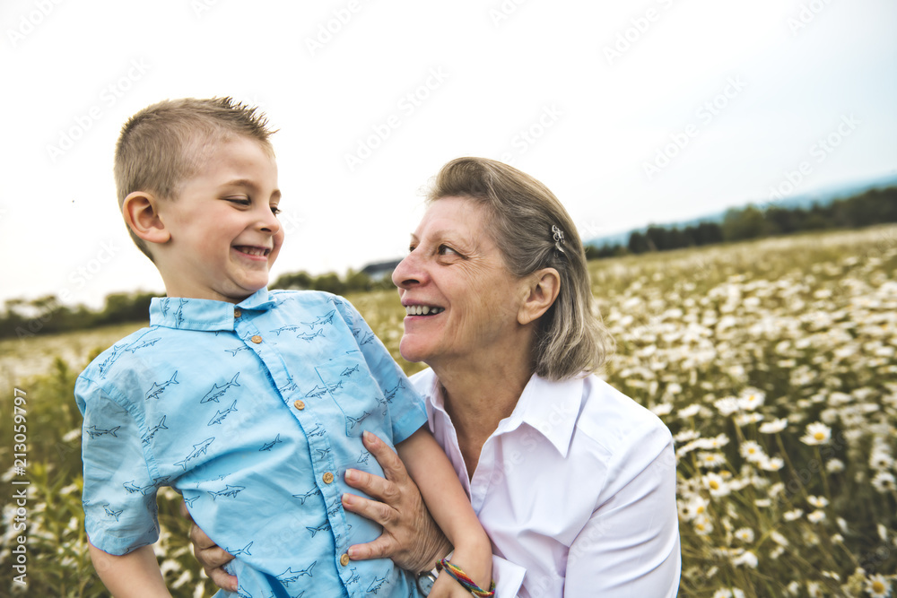 Fototapeta premium grandmother spending time with little child during the sunset.