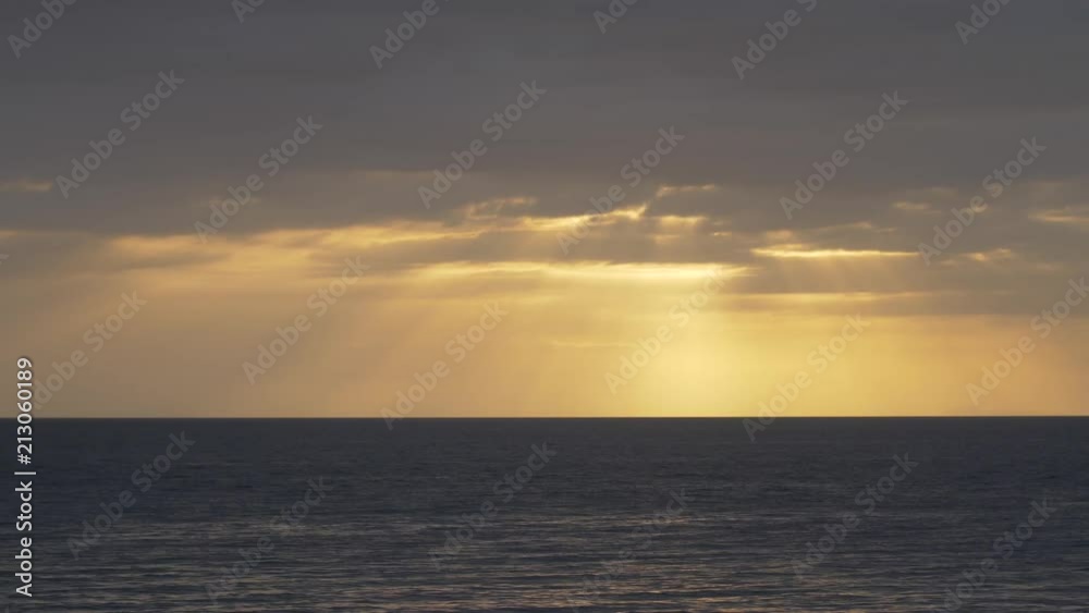 Dramatic sunset with sunrays coming through the clouds Dramatic sunset with sunrays coming through the clouds