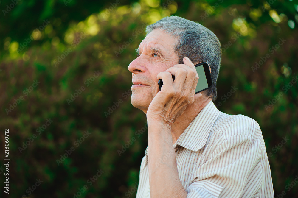 Grandfather with mobile phone in hand Grandfather with mobile phone in hand