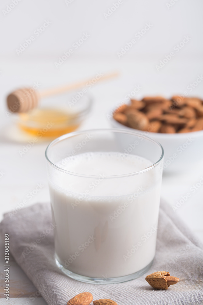 Almond milk and honey on a white wooden table. Almond milk and honey on a white wooden table.