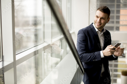 Handsome businessman using ...