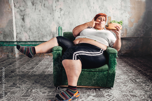 Fat woman eats sandwich, overweight, fatty photo