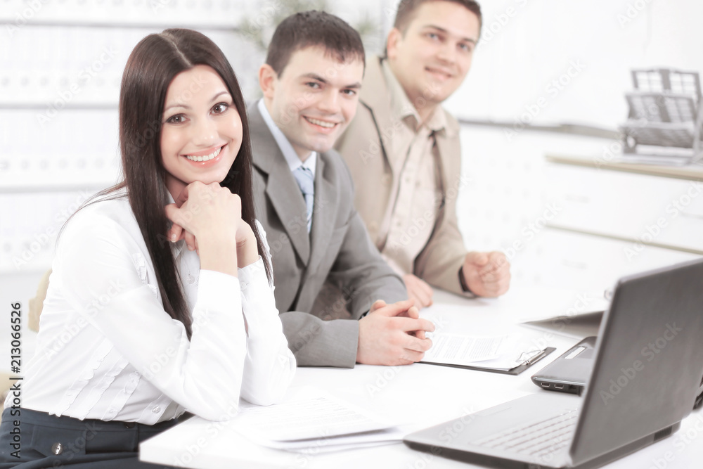 portrait of successful business team sitting at their Desk portrait of successful business team sitting at their Desk