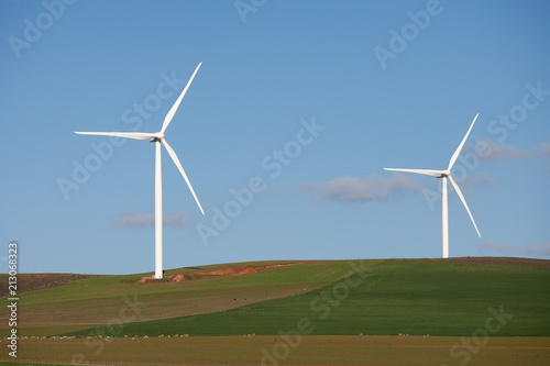 Wind turbines on a hill in rural farmland