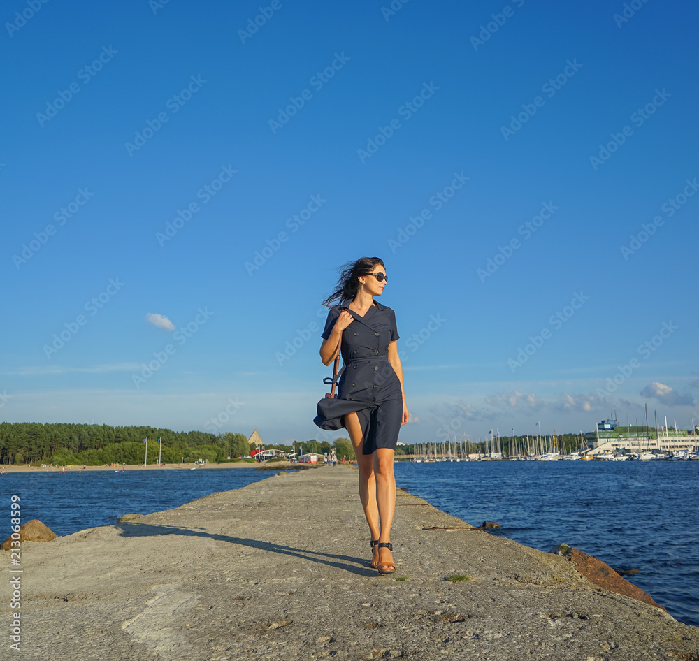 Beautiful woman walking near baltic sea