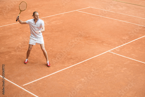 retro styled tennis player with racket on tennis court