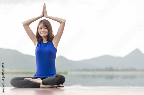 one women doing yoga at the lake view