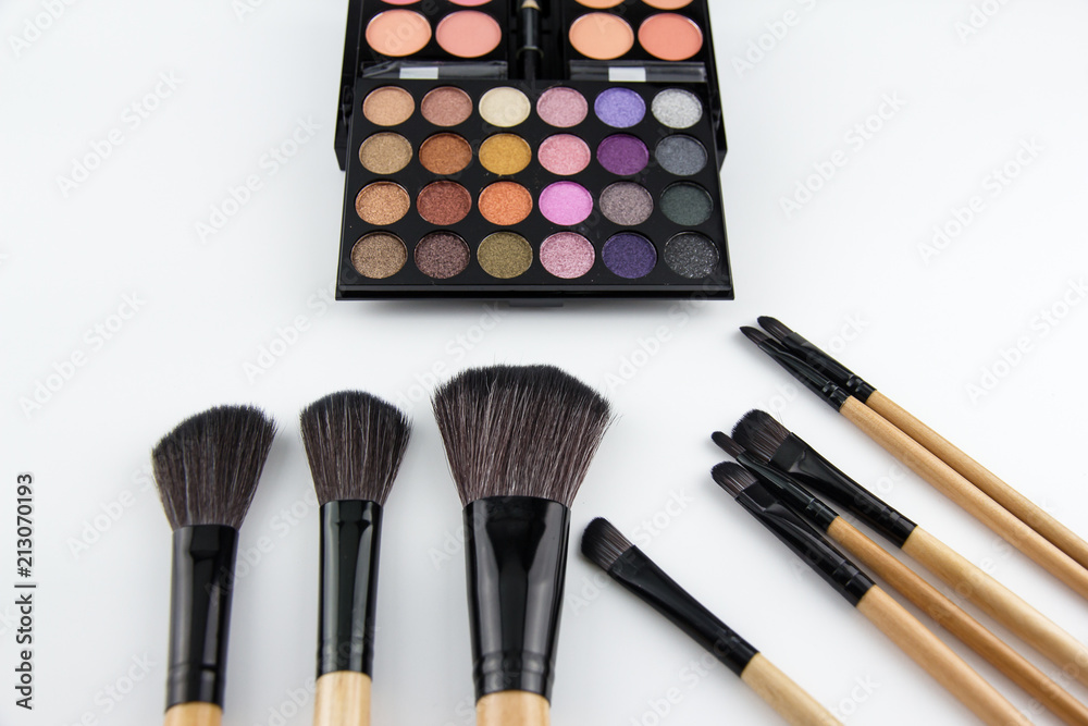 The cosmetic brush set put beside,eyeshadow palette,blurry light around The cosmetic brush set put beside,eyeshadow palette,blurry light around