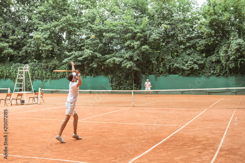 sportsmen playing tennis with wooden rackets on court