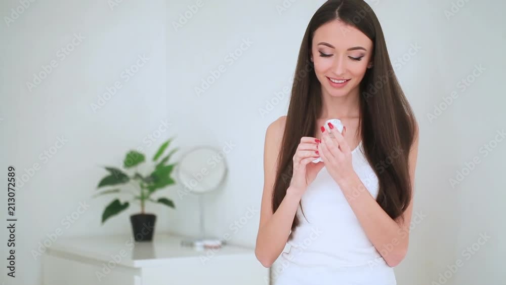 Beauty Face Care. The Portrait of Young Woman With Perfect Skin Applying Cream on Her Skin Beauty Face Care. The Portrait of Young Woman With Perfect Skin Applying Cream on Her Skin