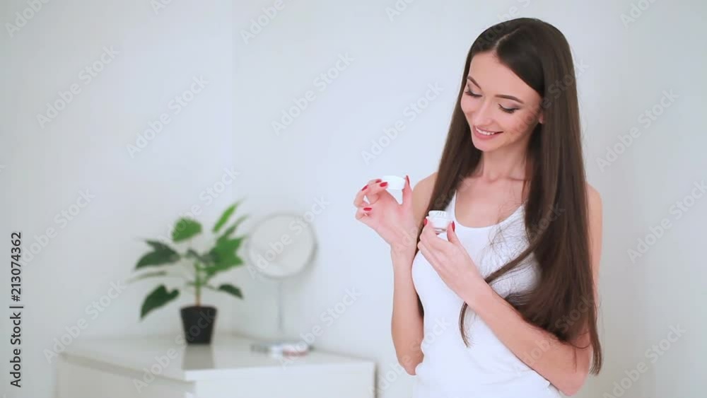 Beauty Face Care. The Portrait of Young Woman With Perfect Skin Applying Cream on Her Skin Beauty Face Care. The Portrait of Young Woman With Perfect Skin Applying Cream on Her Skin