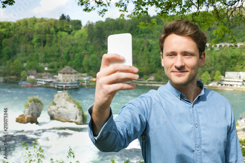 Guy taking a selfie by Rhine falls, Switzerland © taramara78