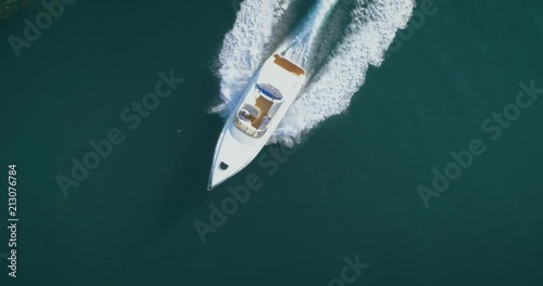 Aerial top down view of recreational speed boat in the atlantic sea, shot in Algarve destination, Portugal.