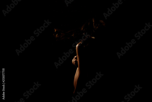 belly of pregnant woman on a dark background