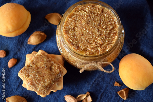 Urbech of apricot kernels in a glass jar and on a cracker photo