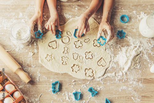 Little Cute Girl and Her Mother Preparing Cookies