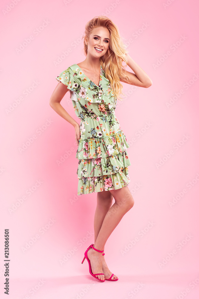 Beautiful fashionable blonde woman in nice dress with flowers, handbag and sunglasses. Fashion spring summer photo. Beautiful fashionable blonde woman in nice dress with flowers, handbag and sunglasses. Fashion spring summer photo.