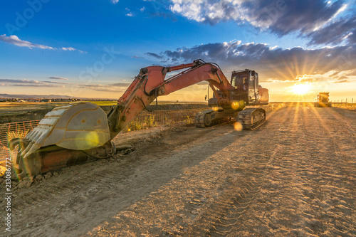 Fotografie Modern excavator machine in remote area on site