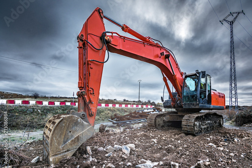 Modern excavator machine in remote area on site photo