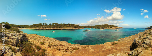 Beautiful coastal landscape with rocks and clear crystal turquoise sea on a sunny day. Cala s'Amarador beach cove panorama in Majorca Spain. Vacation concept.