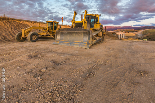 Bulldozer on roadside of unpaved highway