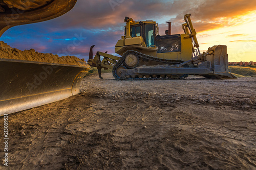 Bulldozer on roadside of unpaved highway